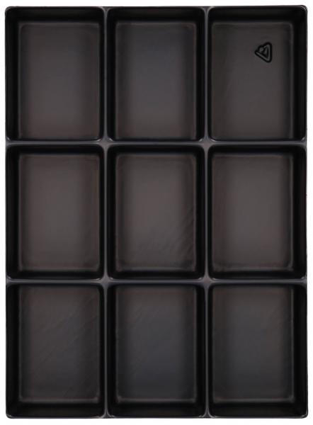 The image shows a black baking pan with nine rectangular indentations, arranged in three rows and three columns. Each indentation has a clear, square border.