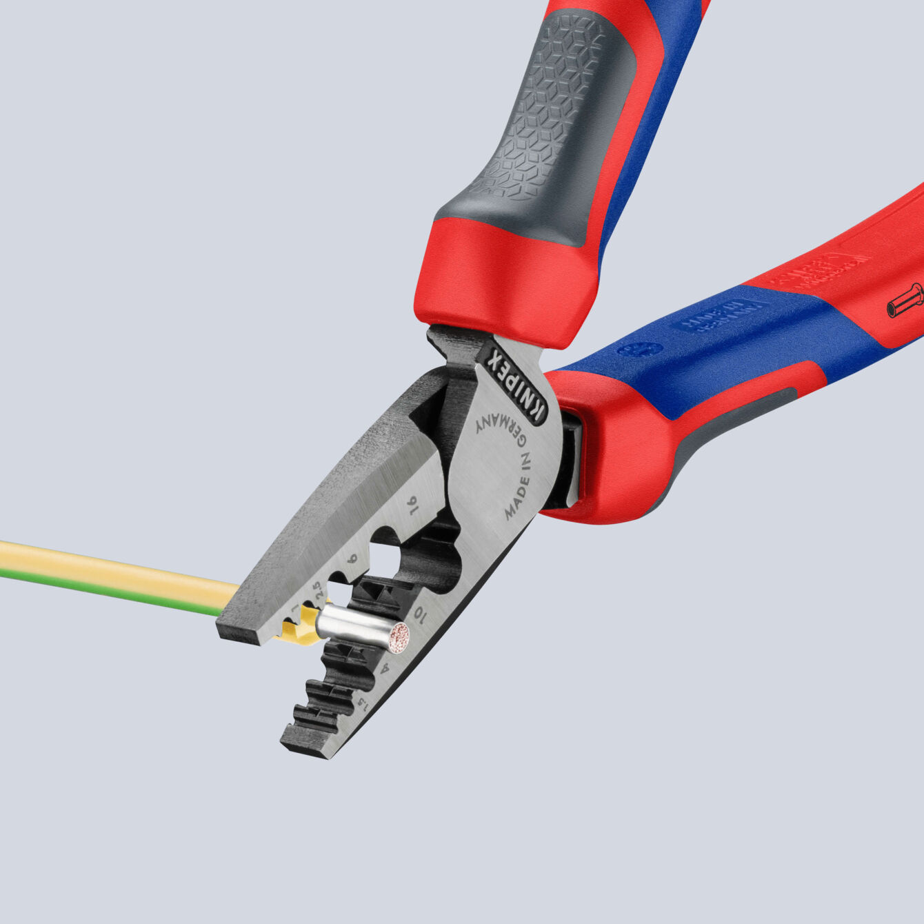 The image displays a wire stripping pliers. The pliers have red and gray grip areas and a metallic blade with various notches for different cable sizes.