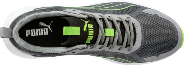 The image shows a gray sports shoe with light green accents. The shoe has a breathable surface and is equipped with laces. The Puma logo is visible on the tongue.