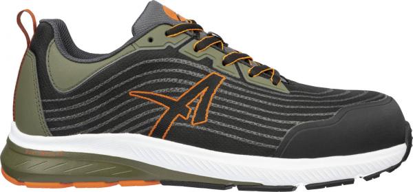 The shoe is a sporty sneaker with a black upper, gray and olive green accents. The sole is white and the shoe has orange details and laces.