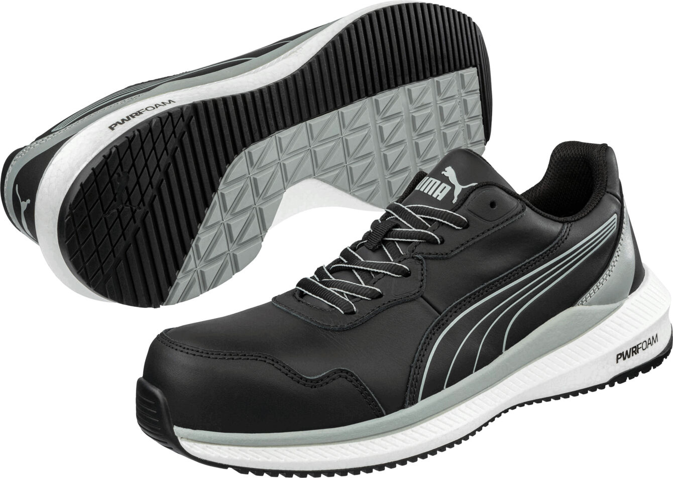 The picture shows sporty, black-and-white shoes with a gray sole. The shoelaces are gray, and there is a stylish logo stripe on the sides.