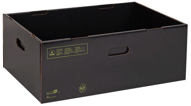 The image shows a black, rectangular cardboard box. It has two side handle holes and is open, without a lid. The surface is textured and there are some symbols on the front.