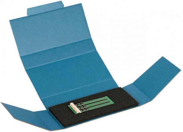 The image shows an open, blue package. In the center, three green, flat objects rest on a velvety black background. The package has flaps on both sides.