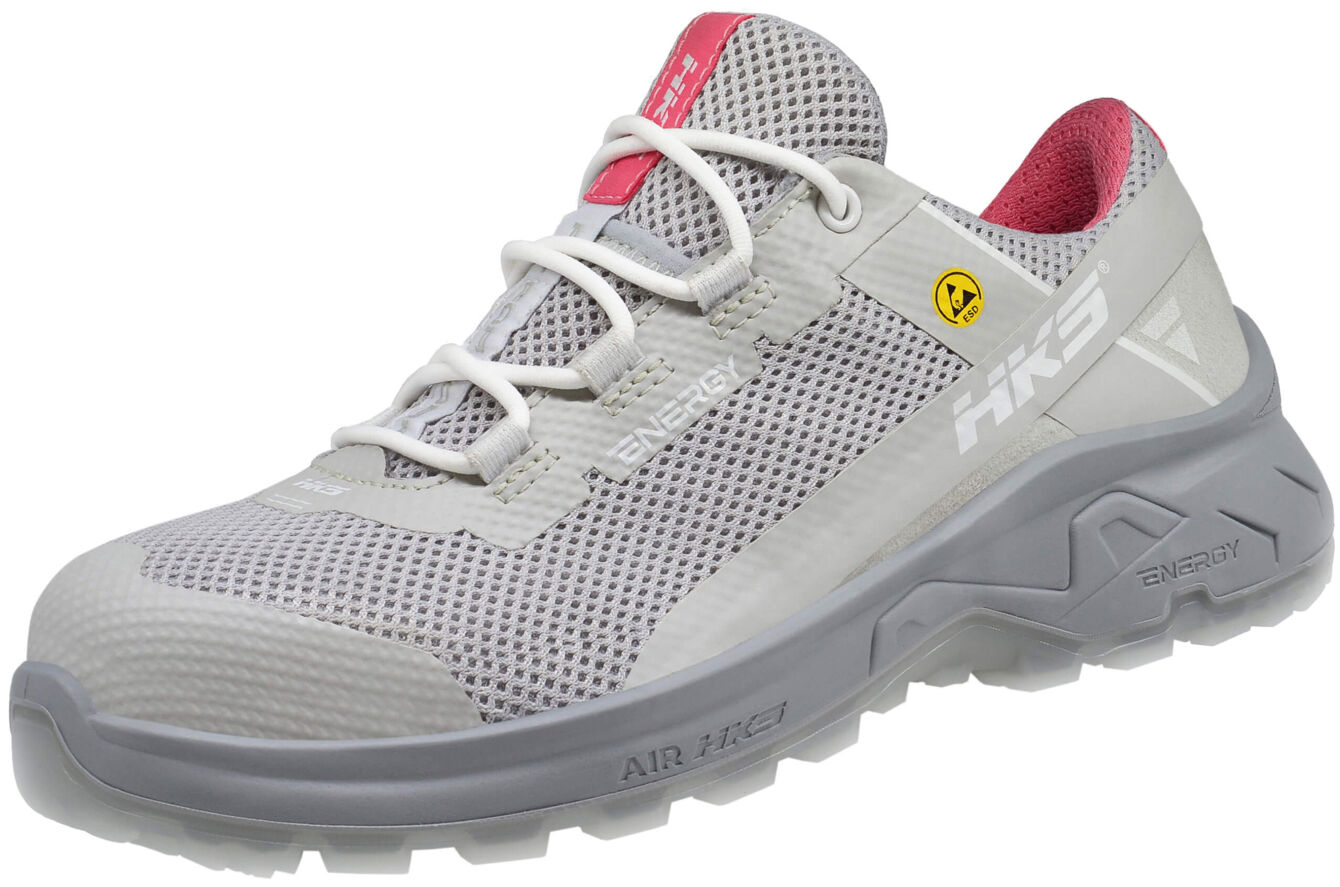 The shoe is lightweight and breathable, with a gray upper and pink accents. The sole is grippy and thick, ideal for outdoor activities. Laces ensure a secure fit.