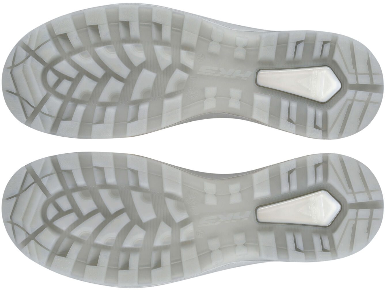 The image displays the sole of a shoe from above. It is predominantly light and transparent with a textured pattern that provides better grip. In the center, there is a distinctive feature in the shape of a small, light rectangle.