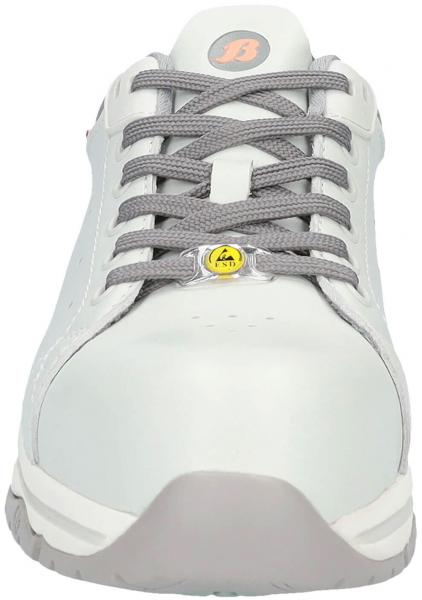 The image shows a gray shoe with a silver top and gray laces. The toe is rounded, the sole is light and textured. A logo is visible on the tongue.