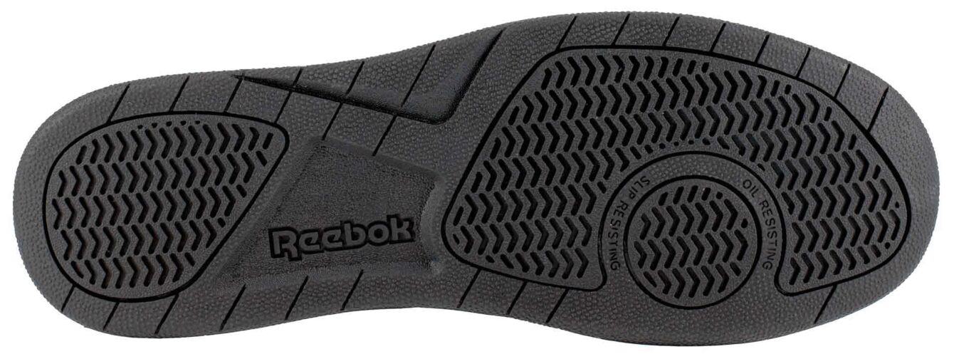 The image displays the underside of a black shoe. It features a textured tread with various grooves and patterns for enhanced grip. The brand "Reebok" is embossed.