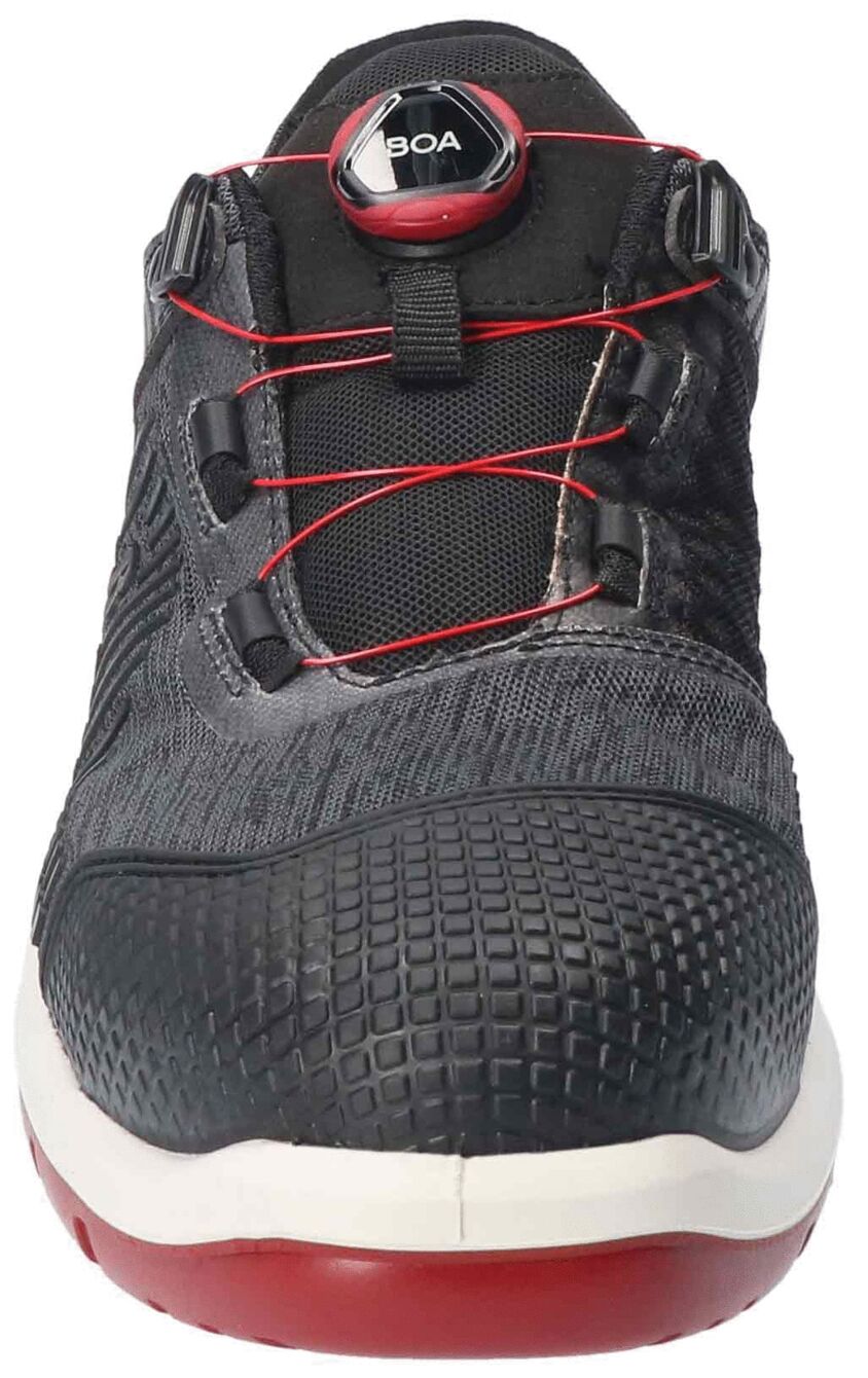 The image shows a modern, black sports shoe with red shoelaces. The shoe has a textured surface and a sturdy, non-slip sole. A closure mechanism is visible on the top.