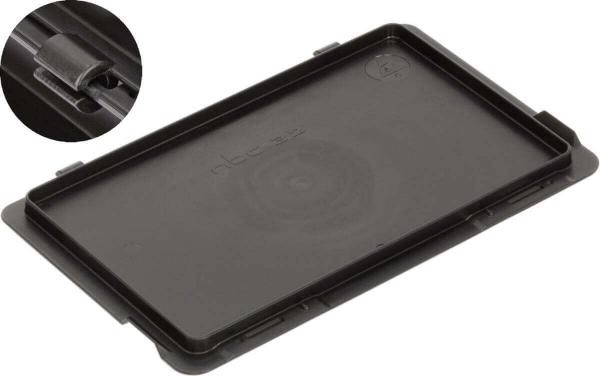 The image shows a black, flat plastic plate with slightly raised edges. In the upper corner, there is a small, round cutout, presumably for a mechanism or a mount.