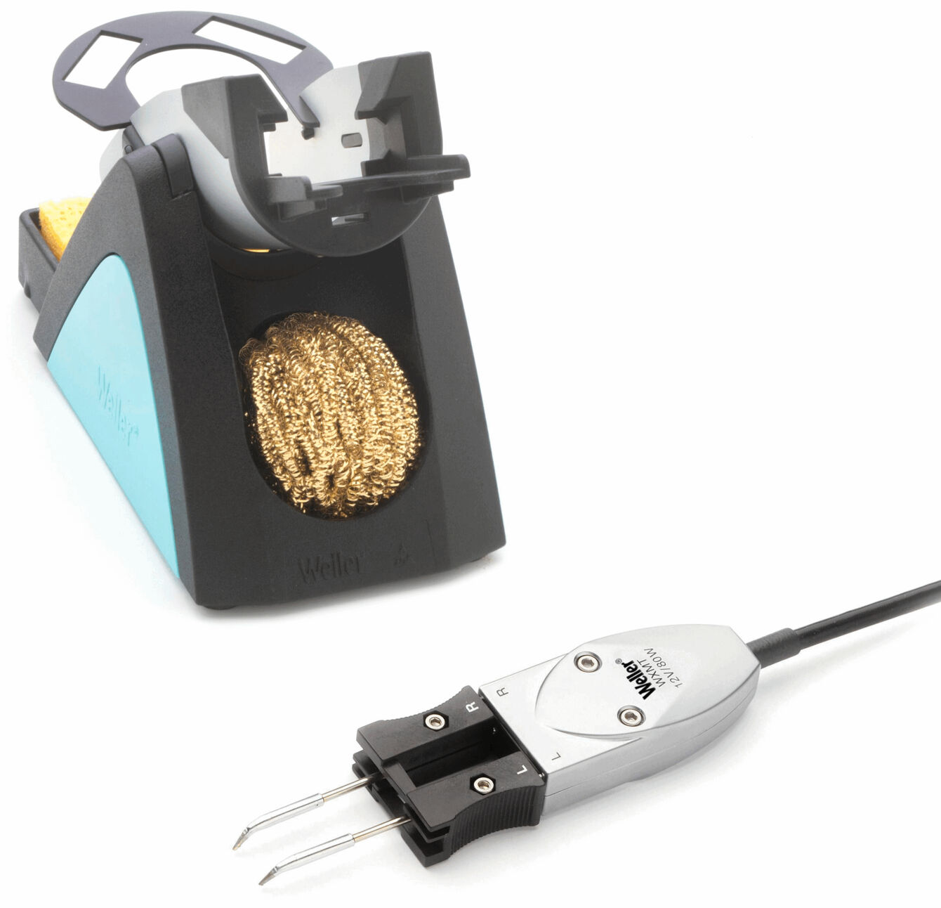 The image shows a soldering iron stand with a gold-colored cleaning brush. Next to the stand is a digital soldering iron with two pointed metal probes and a cable.