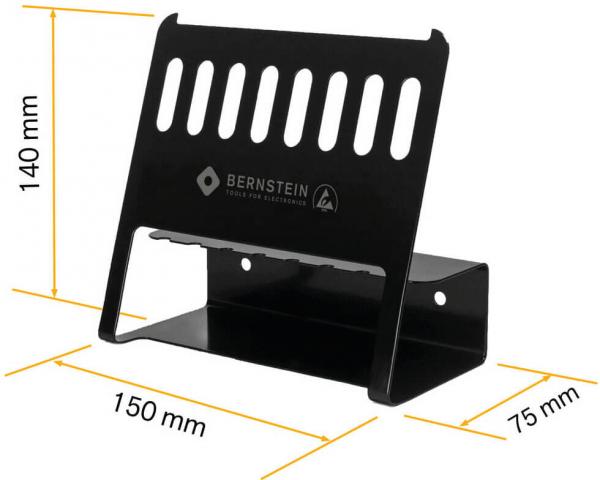 The image shows a black metal holder with vertical slots. It is 140 mm high, 150 mm wide, and 75 mm deep. It is used for storing tools or electronics.