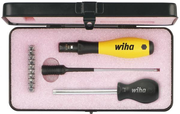 The image shows a black toolbox with a pink lining. Inside, there is a yellow screwdriver and two other tools of different lengths.