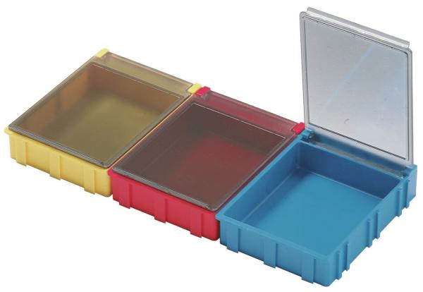 The image shows three small storage boxes in yellow, red, and blue. The yellow and the red ones are closed, the blue one has a lid that is open. They are made of plastic.