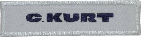 The image displays a textile name tag with a gray background and the bolded name "C. KURT" in dark blue lettering. The edges are serged.