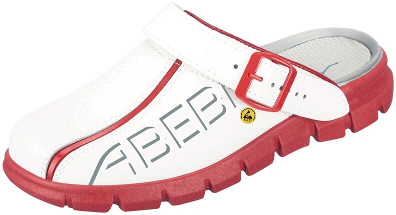 The image shows a white clog with a red rubber sole. It features an adjustable strap and large, gray lettering on the side. The sole is grippy and thick.