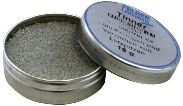 The image shows a round, metal tin with a screwable lid. The tin is partially open and contains gray, fine material. The lid reads "Timber".