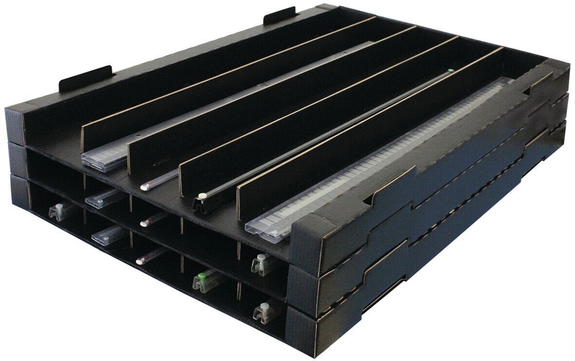 The image shows a black, stackable tray with several narrow compartments. These are arranged horizontally to organize items such as pens or note cards.