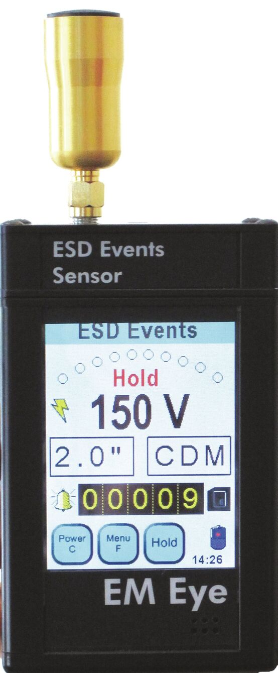 The image shows a device called EM Eye, which is used for measuring electrostatic discharges (ESD). It has a small screen displaying measurements and an antenna on top.